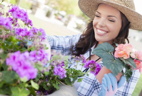 Professional gardener trimming a hedge