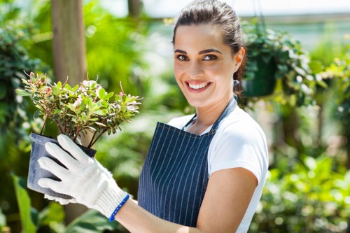 Gardener pruning plants in Chelsea garden