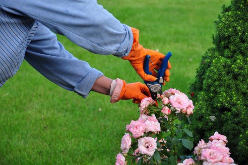 Operative using protective gloves and eye protection while trimming